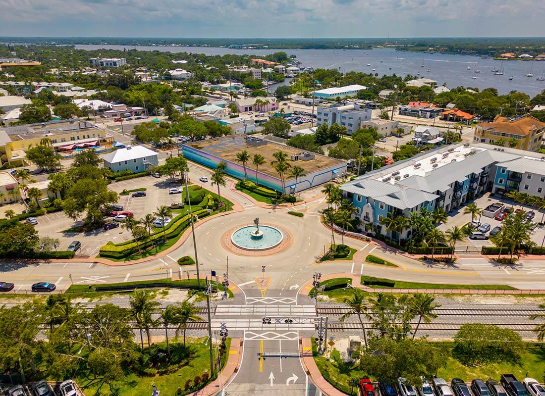 Stuart, FL - Aerial View of Historic Downtown Stuart Florida with Palm Trees Surrounding Buildings on a Sunny Day